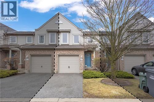 Traditional-style house with a garage, driveway, and brick siding - 26 Roehampton Crescent, Guelph, ON - Outdoor With Facade