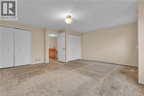 Unfurnished bedroom with two closets and baseboards - 26 Roehampton Crescent, Guelph, ON - Indoor Photo Showing Other Room