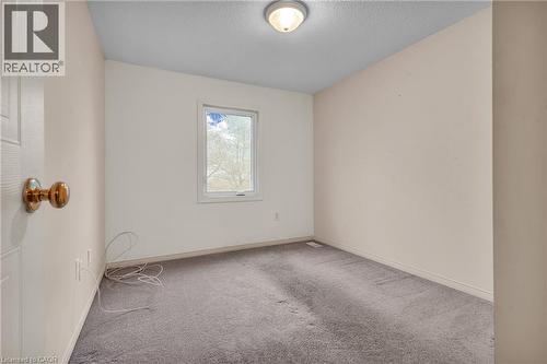Spare room with light colored carpet and a textured ceiling - 26 Roehampton Crescent, Guelph, ON - Indoor Photo Showing Other Room
