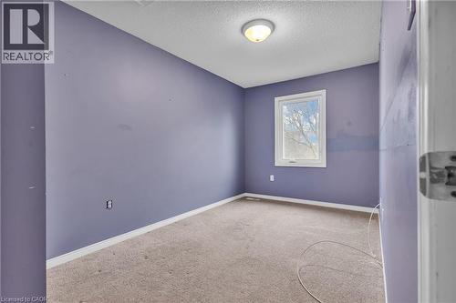 Spare room featuring a textured ceiling and light carpet - 26 Roehampton Crescent, Guelph, ON - Indoor Photo Showing Other Room