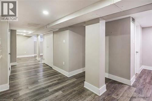 Finished below grade area featuring baseboards and dark wood-type flooring - 27 Ashley Street, Hamilton, ON - Indoor