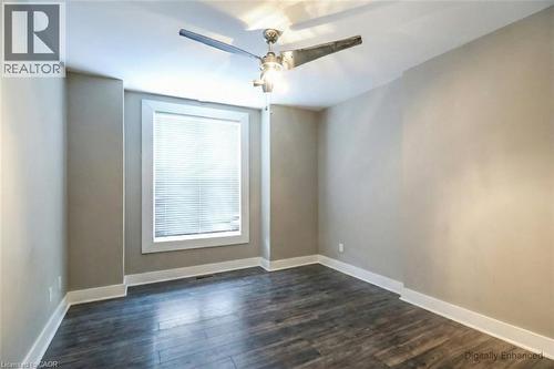 Empty room with dark wood finished floors and a ceiling fan - 27 Ashley Street, Hamilton, ON - Indoor Photo Showing Other Room