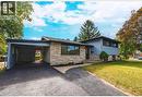 Tri-level home with stone siding, a front lawn, a carport, and driveway - 267 Erb Street E, Waterloo, ON  - Outdoor 