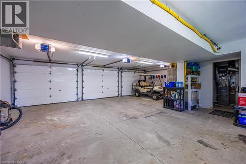 3 bay garage with walkout to yard and roughed in bathroom - 1285 Cockshutt Road, Simcoe, ON - Indoor Photo Showing Garage