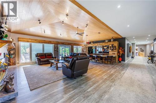 Living area with light wood-style floors, a ceiling fan, a vaulted wood ceiling, and a fireplace - 1285 Cockshutt Road, Simcoe, ON - Indoor