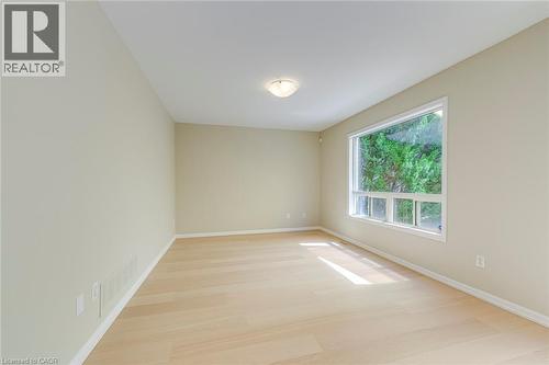 Family room featuring baseboards and light wood-style flooring - 3037 Abernathy Way, Oakville, ON - Indoor Photo Showing Other Room