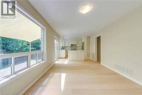 Family room with light wood-style floors and baseboards - 3037 Abernathy Way, Oakville, ON - Indoor Photo Showing Other Room