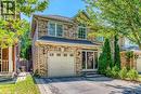 Traditional home featuring an attached garage, driveway, and a shingled roof - 3037 Abernathy Way, Oakville, ON  - Outdoor 