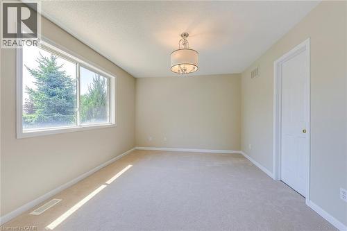 Primary bedroom featuring light carpet and a textured ceiling - 3037 Abernathy Way, Oakville, ON - Indoor Photo Showing Other Room