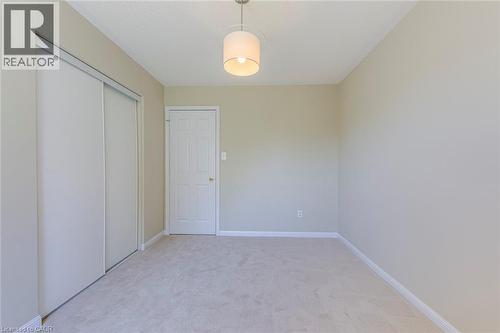 Bedroom 2 with light colored carpet and a closet - 3037 Abernathy Way, Oakville, ON - Indoor Photo Showing Other Room
