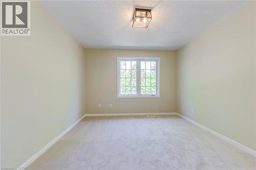Bedroom 3 featuring light colored carpet and a textured ceiling - 3037 Abernathy Way, Oakville, ON - Indoor Photo Showing Other Room