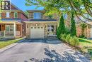 View of front of house with asphalt driveway, an attached garage, a porch, and brick siding - 3037 Abernathy Way, Oakville, ON  - Outdoor 