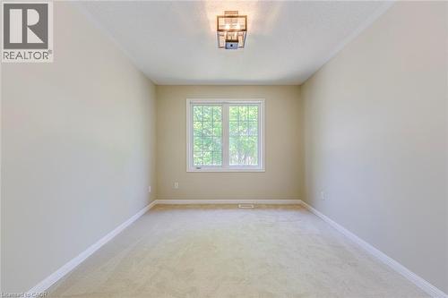 Bedroom 4 with light colored carpet and a textured ceiling - 3037 Abernathy Way, Oakville, ON - Indoor Photo Showing Other Room
