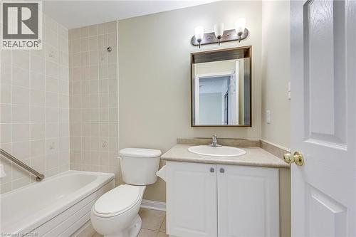 Bathroom with vanity, bathing tub / shower combination, and light tile patterned floors - 3037 Abernathy Way, Oakville, ON - Indoor Photo Showing Bathroom