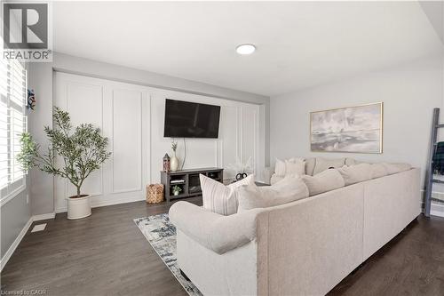 Living area with dark wood-style flooring and baseboards - 105 Larry Crescent, Caledonia, ON - Indoor Photo Showing Living Room
