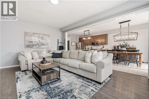 Living room featuring suspended lighting and wood finished floors - 105 Larry Crescent, Caledonia, ON - Indoor Photo Showing Living Room