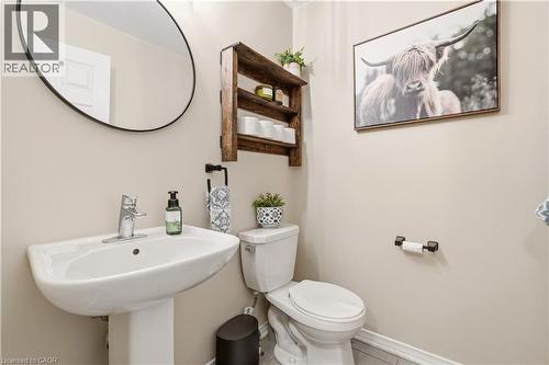 Half bathroom featuring toilet and baseboards - 105 Larry Crescent, Caledonia, ON - Indoor Photo Showing Bathroom