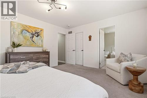 Carpeted bedroom with baseboards and ensuite bathroom - 105 Larry Crescent, Caledonia, ON - Indoor Photo Showing Bedroom