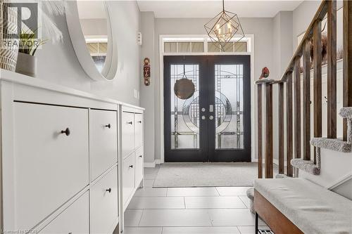 Entrance foyer featuring french doors and hanging lights - 105 Larry Crescent, Caledonia, ON - Indoor Photo Showing Other Room