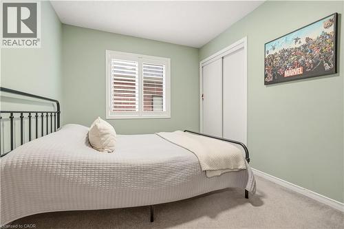 Carpeted bedroom with baseboards and a closet - 105 Larry Crescent, Caledonia, ON - Indoor Photo Showing Bedroom