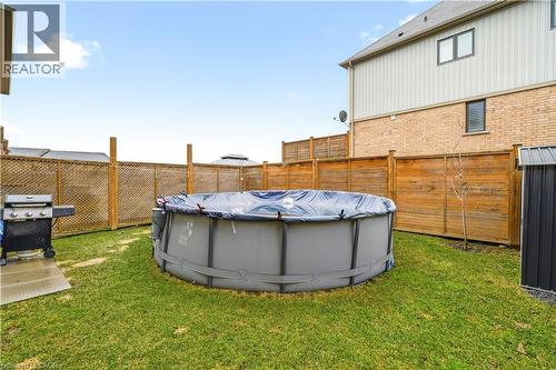 View of fenced backyard - 105 Larry Crescent, Caledonia, ON - Outdoor With Above Ground Pool With Exterior