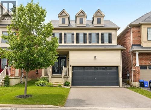 View of front of property featuring driveway, an attached garage, and a front lawn - 105 Larry Crescent, Caledonia, ON - Outdoor With Facade