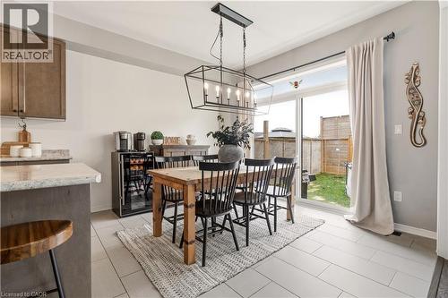 Dining space featuring suspended lighting and light tile patterned floors - 105 Larry Crescent, Caledonia, ON - Indoor Photo Showing Dining Room