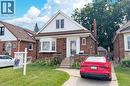 Brick-front residence featuring a prominent bay window, white siding accents, and a brown shingle roof - 143 Huxley Avenue S, Hamilton, ON  - Outdoor With Facade 