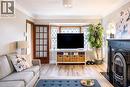 Living room with light wood finished floors and a fireplace with flush hearth - 143 Huxley Avenue S, Hamilton, ON  - Indoor 