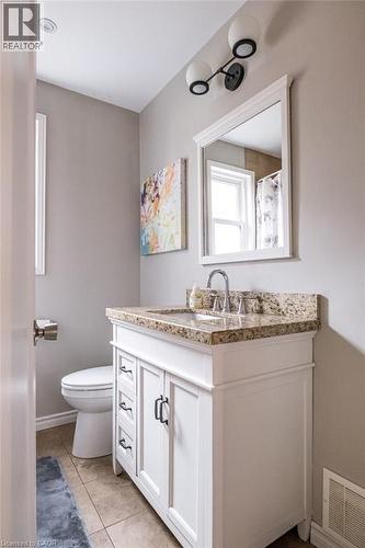 Full bathroom with vanity, a shower with curtain, and light tile patterned floors - 143 Huxley Avenue S, Hamilton, ON - Indoor Photo Showing Bathroom
