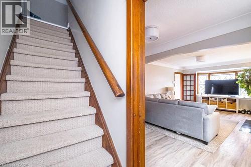 Staircase featuring arched walkways and wood finished floors - 143 Huxley Avenue S, Hamilton, ON - Indoor Photo Showing Other Room