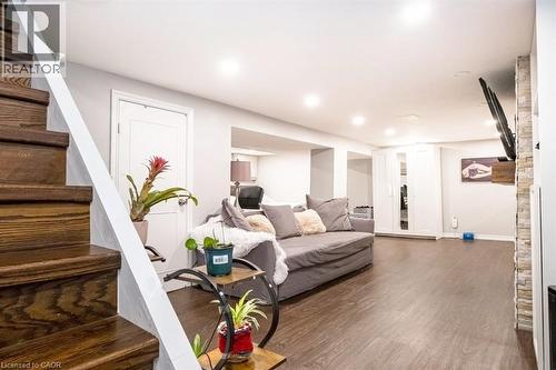 Living room featuring stairway and wood finished floors - 143 Huxley Avenue S, Hamilton, ON - Indoor
