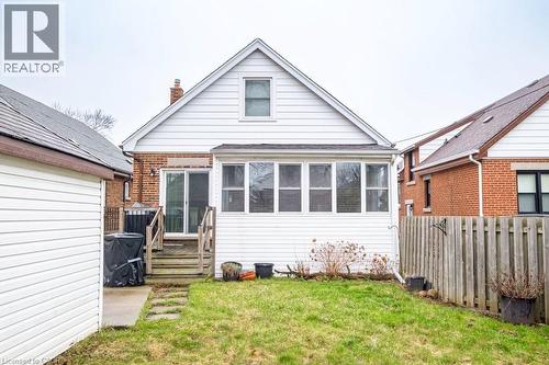 Back of house featuring a chimney and brick siding - 143 Huxley Avenue S, Hamilton, ON - Outdoor With Exterior
