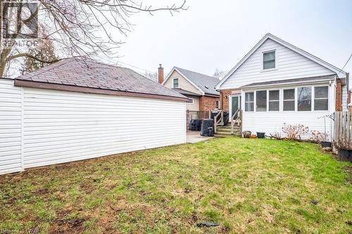 Rear view of property with a sunroom, an outdoor structure, and a patio - 143 Huxley Avenue S, Hamilton, ON - Outdoor