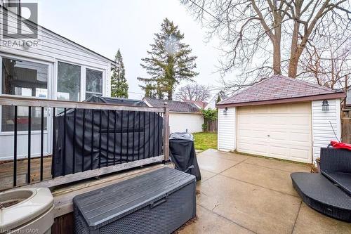 View of patio with an outbuilding, a grill, a garage, and driveway - 143 Huxley Avenue S, Hamilton, ON - Outdoor With Exterior