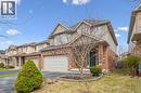 View of front of property with asphalt driveway, brick siding, a garage, and a front lawn - 512 Wood Nettle Way, Waterloo, ON  - Outdoor With Facade 