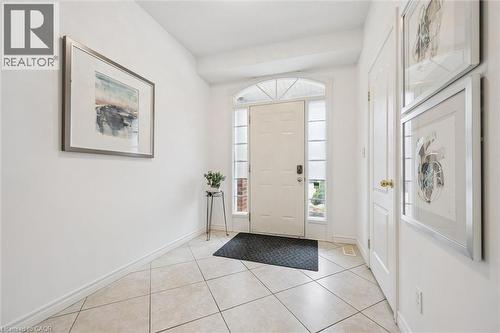 Entryway featuring baseboards and light tile patterned flooring - 512 Wood Nettle Way, Waterloo, ON - Indoor Photo Showing Other Room