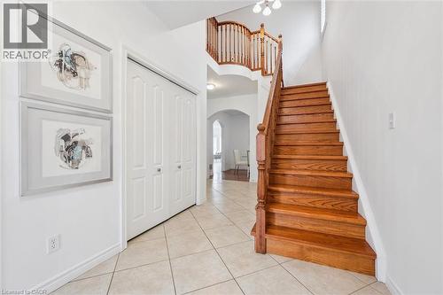 Stairs with tile patterned flooring, arched walkways, and a high ceiling - 512 Wood Nettle Way, Waterloo, ON - Indoor Photo Showing Other Room