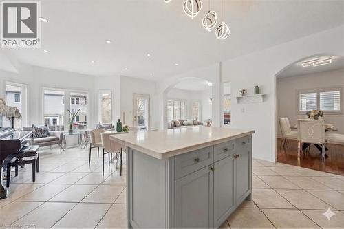 Kitchen island featuring a light-colored countertop and grey cabinetry with brass hardware - 512 Wood Nettle Way, Waterloo, ON - Indoor Photo Showing Other Room