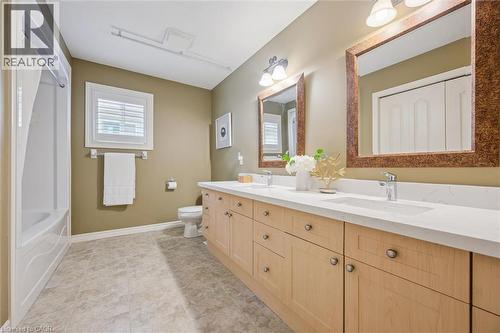 Full bath featuring double vanity, tub / shower combination, and light tile patterned flooring - 512 Wood Nettle Way, Waterloo, ON - Indoor Photo Showing Bathroom