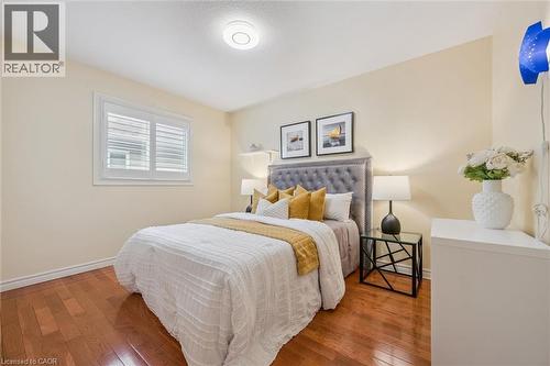 Bedroom with wood-type flooring and baseboards - 512 Wood Nettle Way, Waterloo, ON - Indoor Photo Showing Bedroom