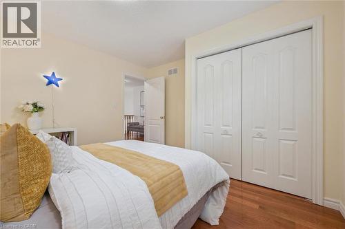 Bedroom with wood finished floors and a closet - 512 Wood Nettle Way, Waterloo, ON - Indoor Photo Showing Bedroom