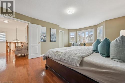 Bedroom featuring hardwood / wood-style floors and hanging lights - 512 Wood Nettle Way, Waterloo, ON - Indoor Photo Showing Bedroom