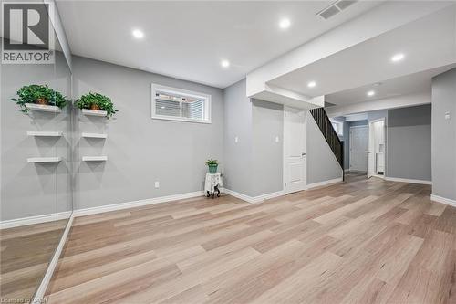 Below grade area with recessed lighting and light wood finished floors - 512 Wood Nettle Way, Waterloo, ON - Indoor
