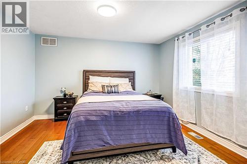 Bedroom featuring wood-type flooring and baseboards - 65 Thistlemoor Drive, Caledonia, ON - Indoor Photo Showing Bedroom