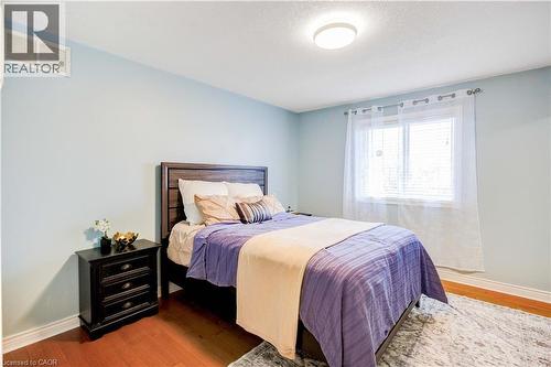 Bedroom featuring baseboards and wood finished floors - 65 Thistlemoor Drive, Caledonia, ON - Indoor Photo Showing Bedroom