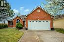 View of front of home featuring brick siding, concrete driveway, a garage, and a front yard - 65 Thistlemoor Drive, Caledonia, ON  - Outdoor 