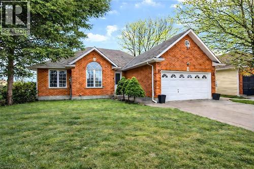 Ranch-style house with an attached garage, driveway, a front yard, and brick siding - 65 Thistlemoor Drive, Caledonia, ON - Outdoor