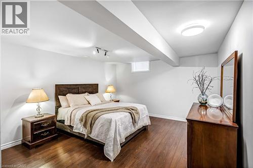 Bedroom with baseboards and dark wood finished floors - 65 Thistlemoor Drive, Caledonia, ON - Indoor Photo Showing Bedroom