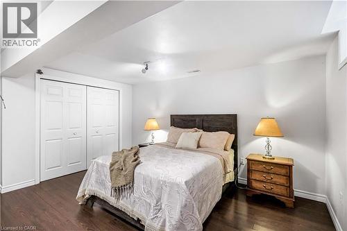Bedroom featuring a closet, dark wood-type flooring, and rail lighting - 65 Thistlemoor Drive, Caledonia, ON - Indoor Photo Showing Bedroom